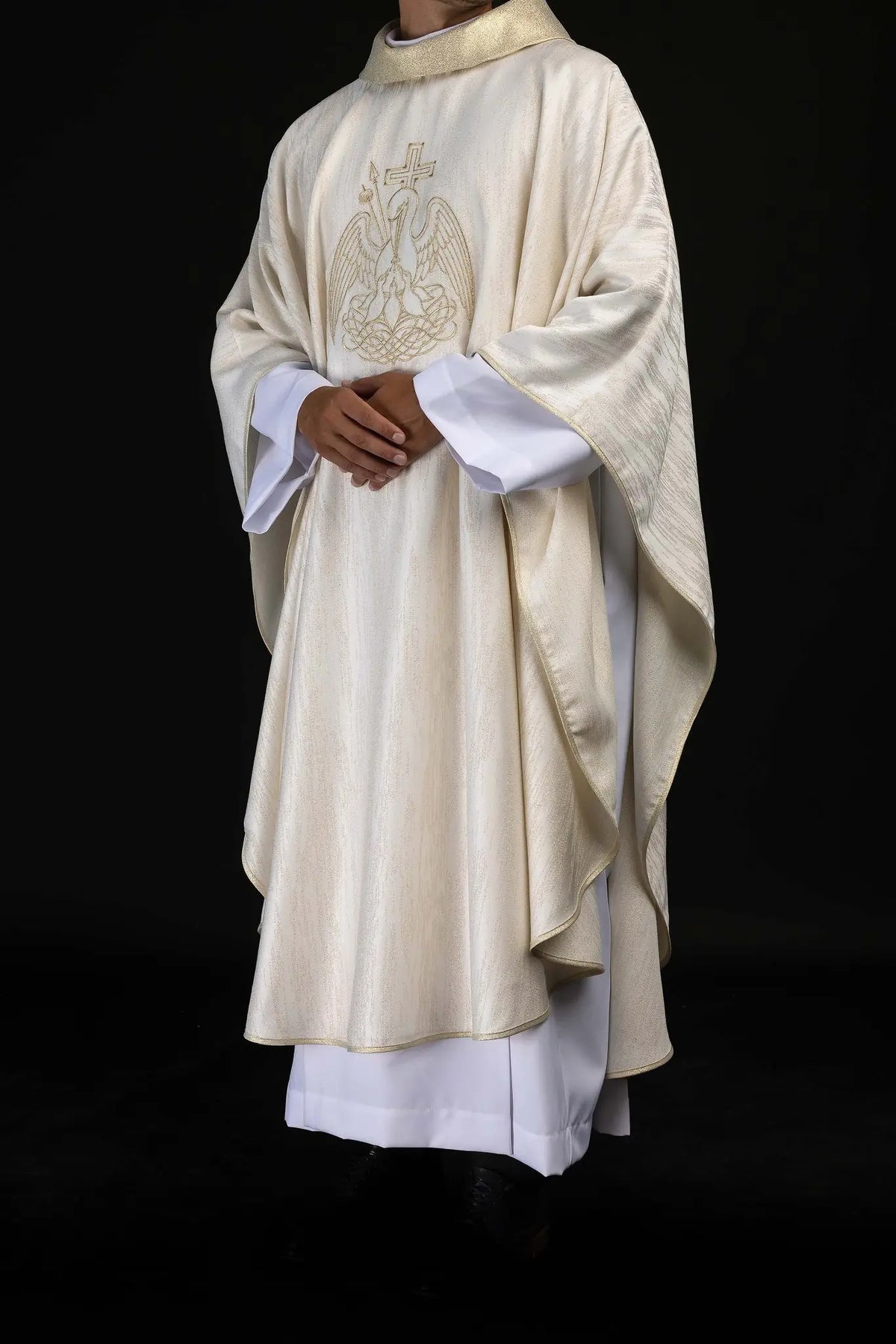 Ecru chasuble with embroidered Eucharistic pelican, worn three-quarter view