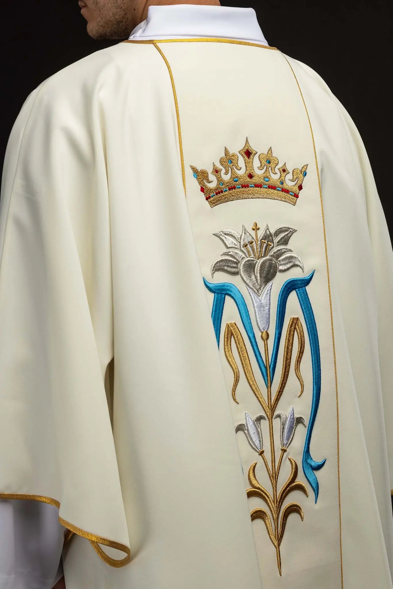 Ecru dalmatic with Marian embroidery, gold trim, and a matching stole.