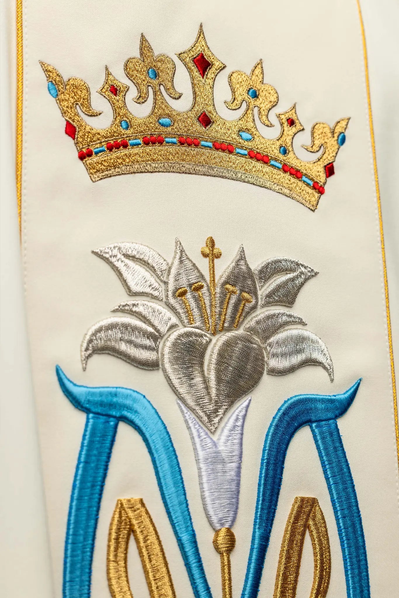 Ecru dalmatic with Marian embroidery, gold trim, and a matching stole.