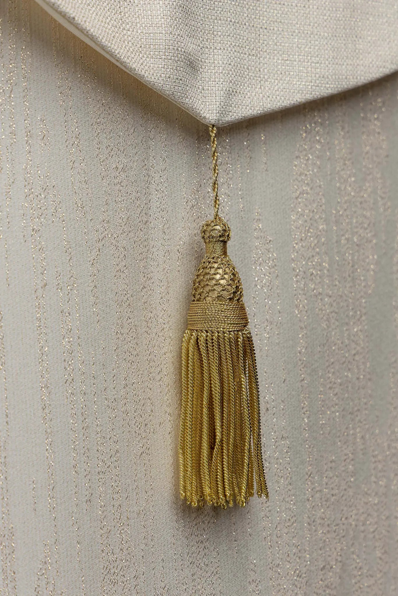 Ecru embroidered cope with Marian symbol, featuring gold and blue floral embroidery, a crowned 'M' monogram, and an ornate gold clasp with chain.