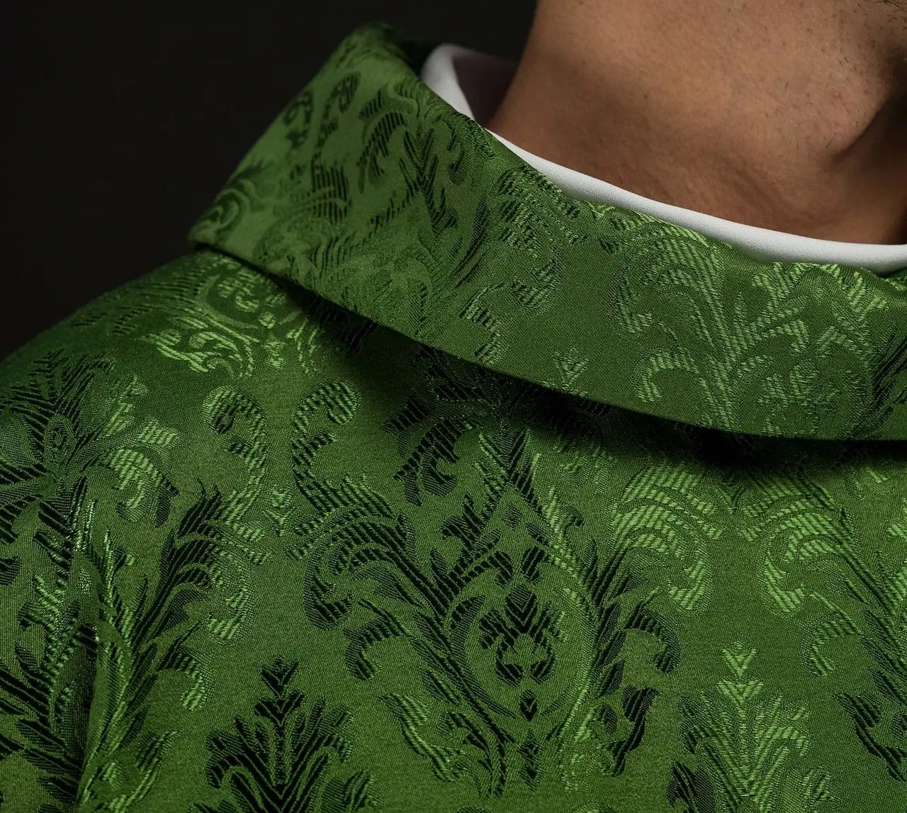 Green chasuble with embroidered IHS motif on decorative fabric
