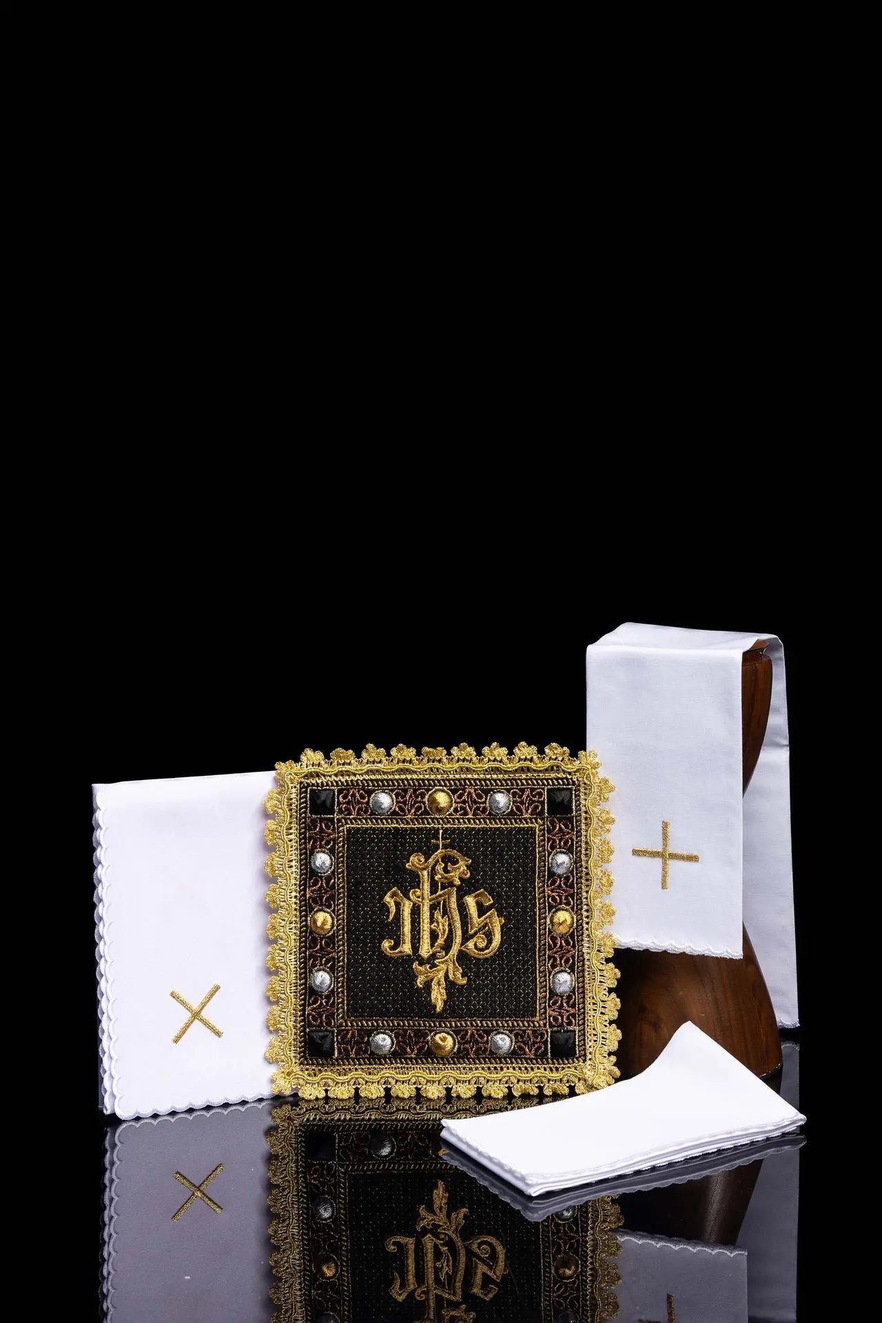 A black velvet chalice linens set with an embroidered IHS symbol