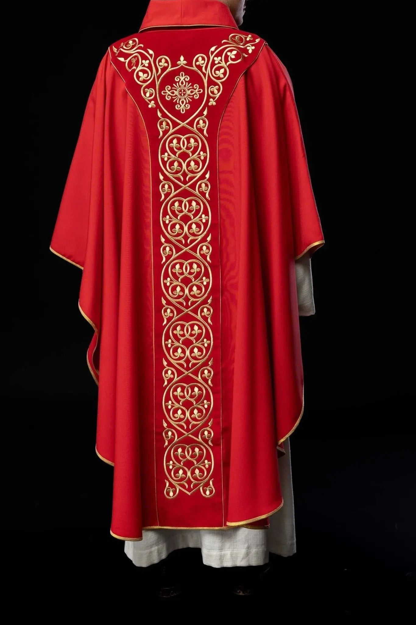 Red liturgical chasuble decorated with embroidery on velvet
