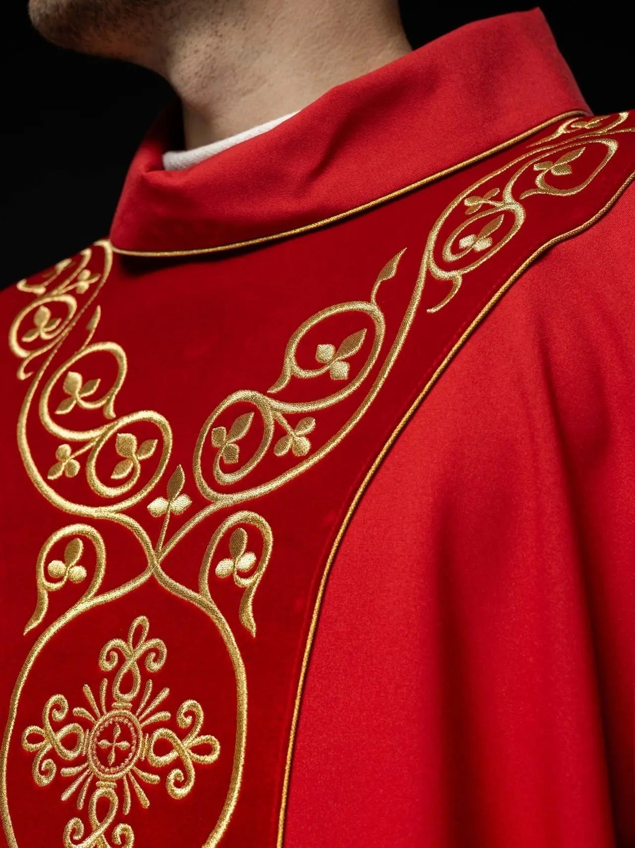 Red liturgical chasuble decorated with embroidery on velvet