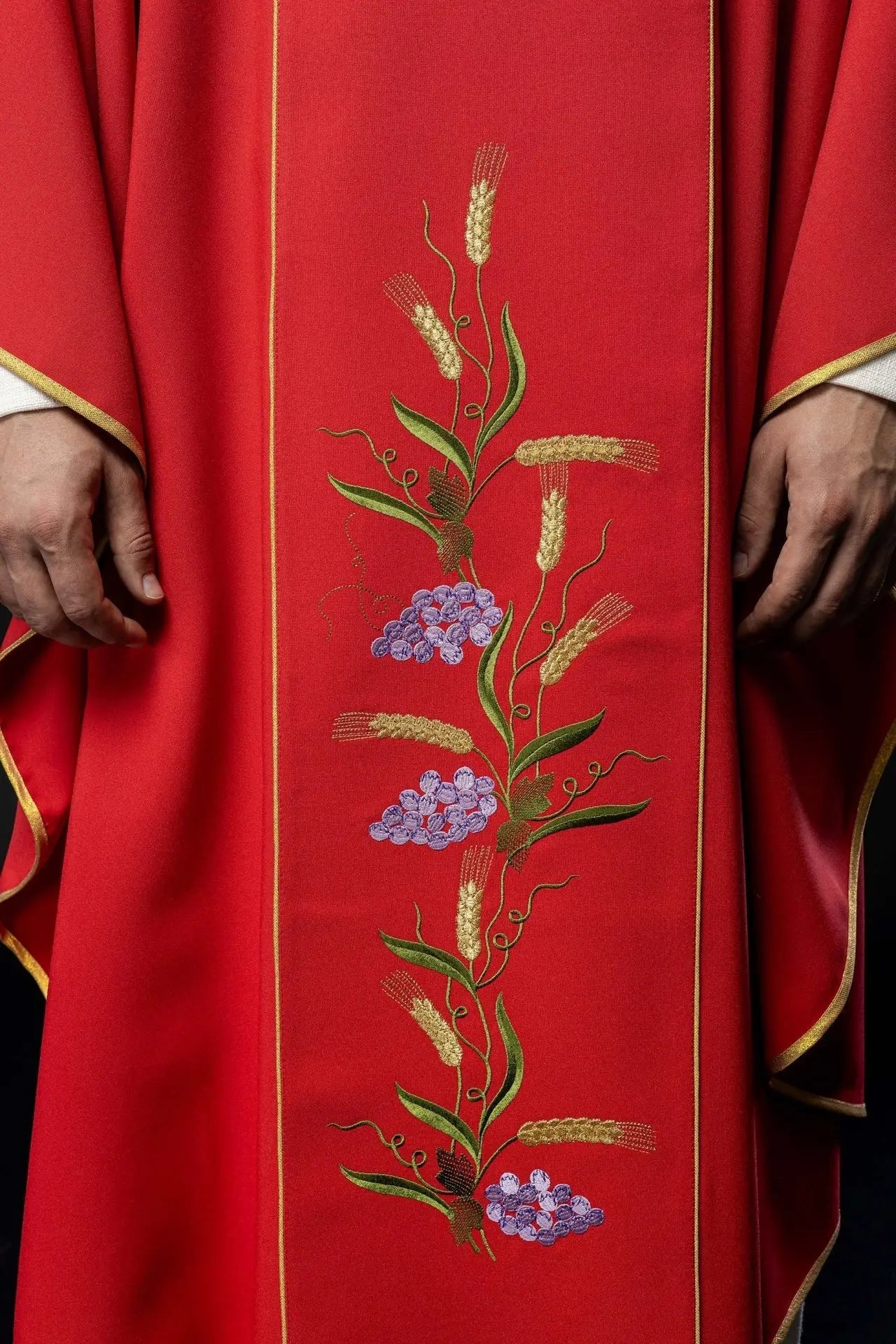 Red chasuble with decorated gold belt with IHS and ears