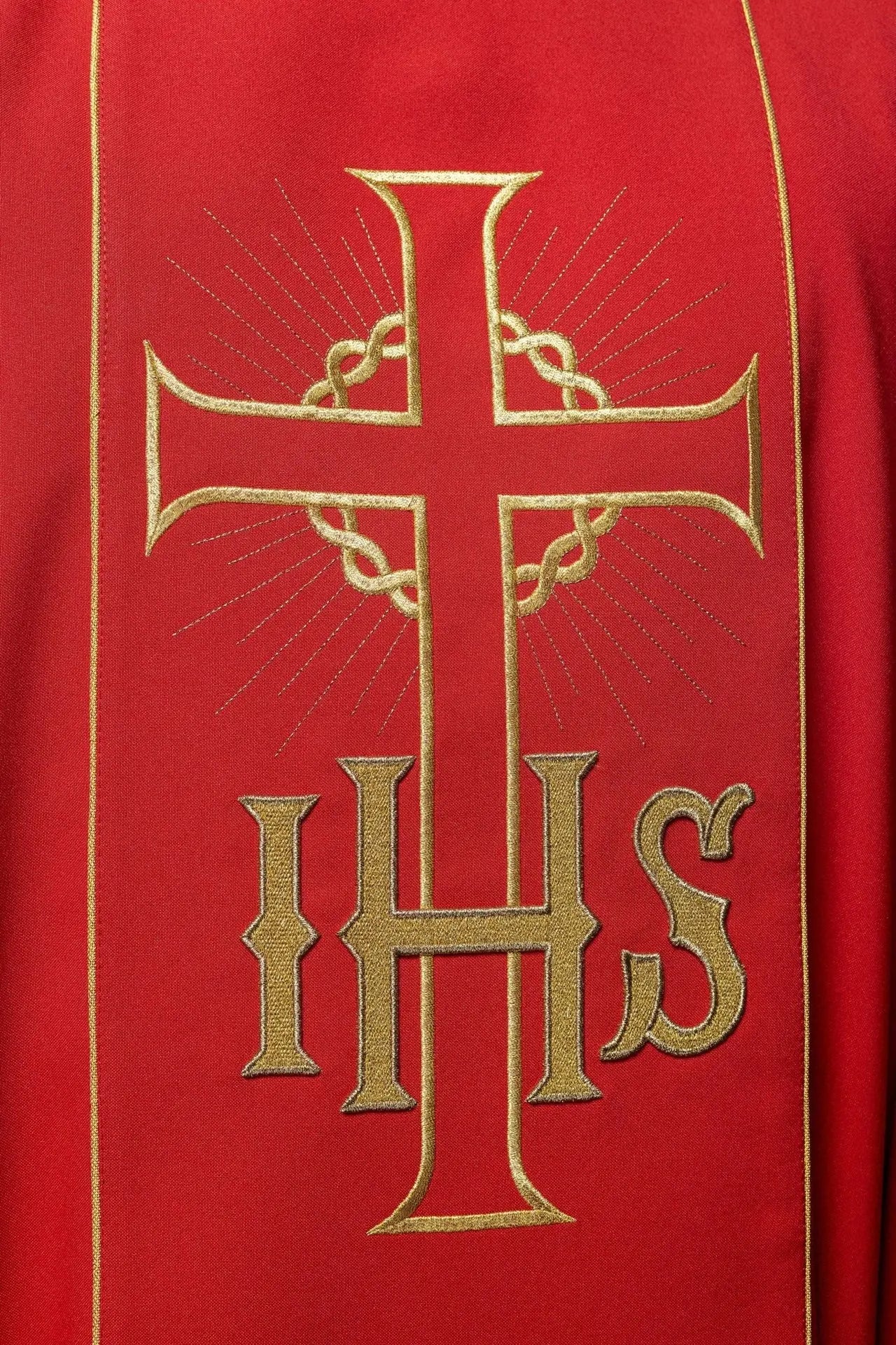 Red chasuble with decorated gold belt with IHS and ears