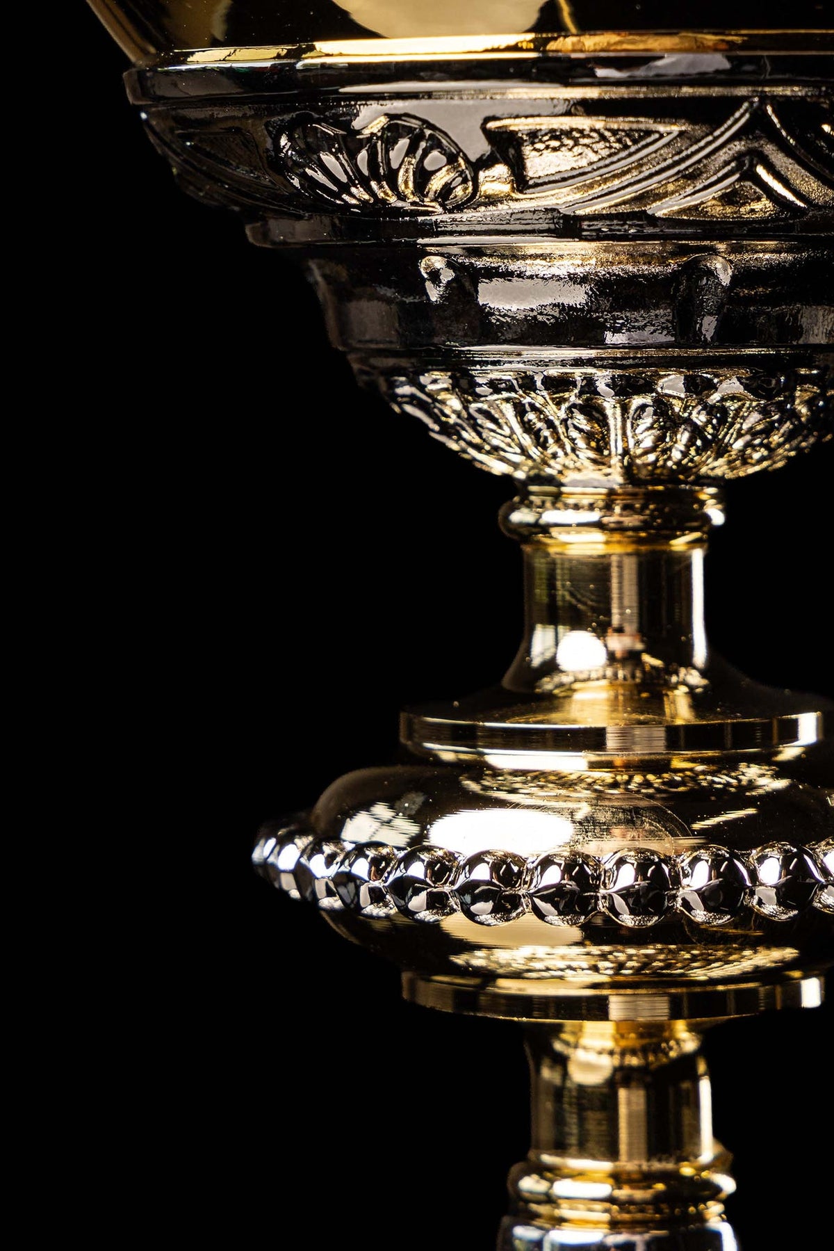 Gold and silver chalice with relief plant motifs, close-up of beaded stem and base