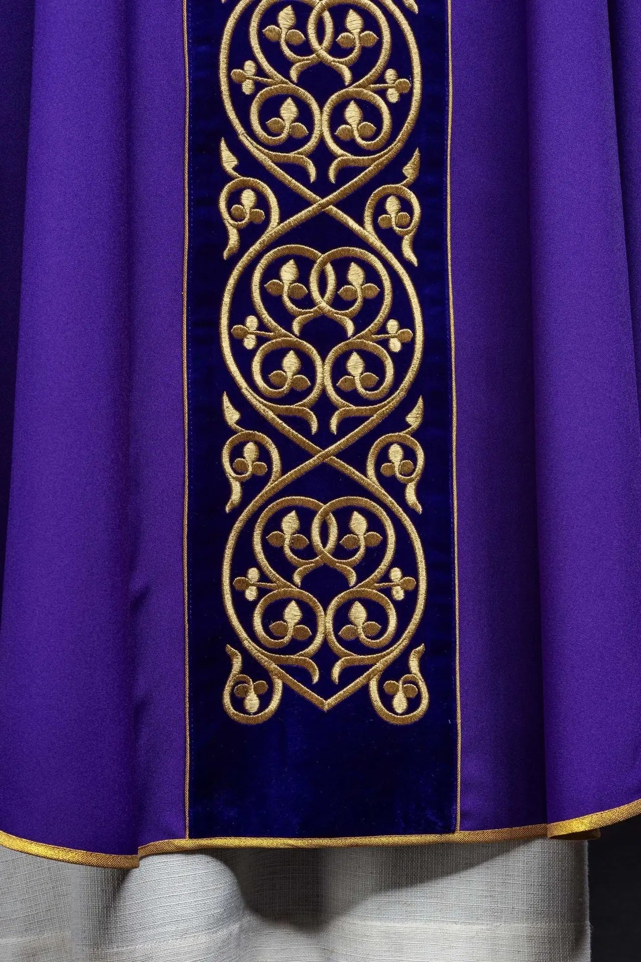Purple liturgical chasuble decorated with embroidery on velvet