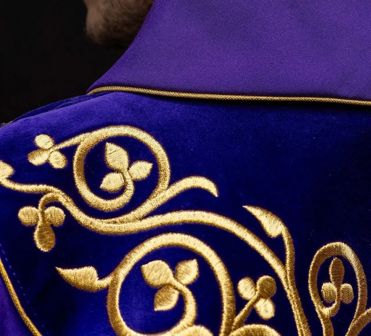 Purple liturgical chasuble decorated with embroidery on velvet