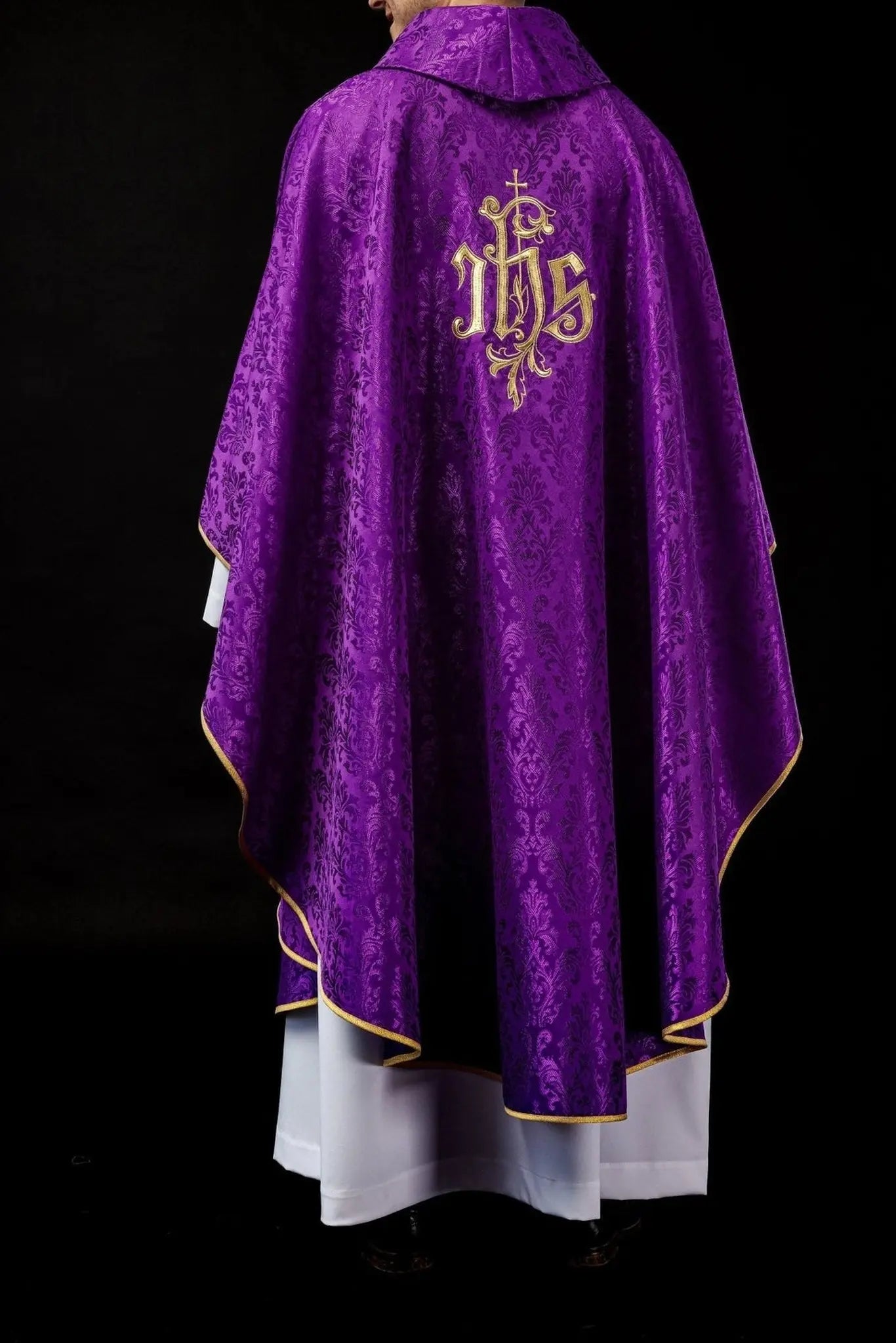 Purple chasuble with embroidered IHS motif on decorative fabric