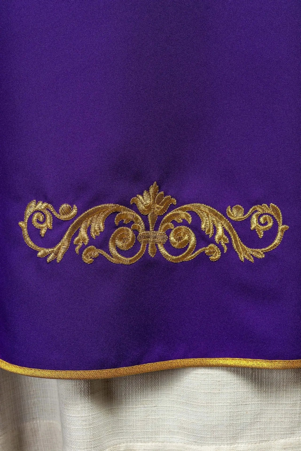 Purple chasuble with gold IHS embroidery and decorative trim