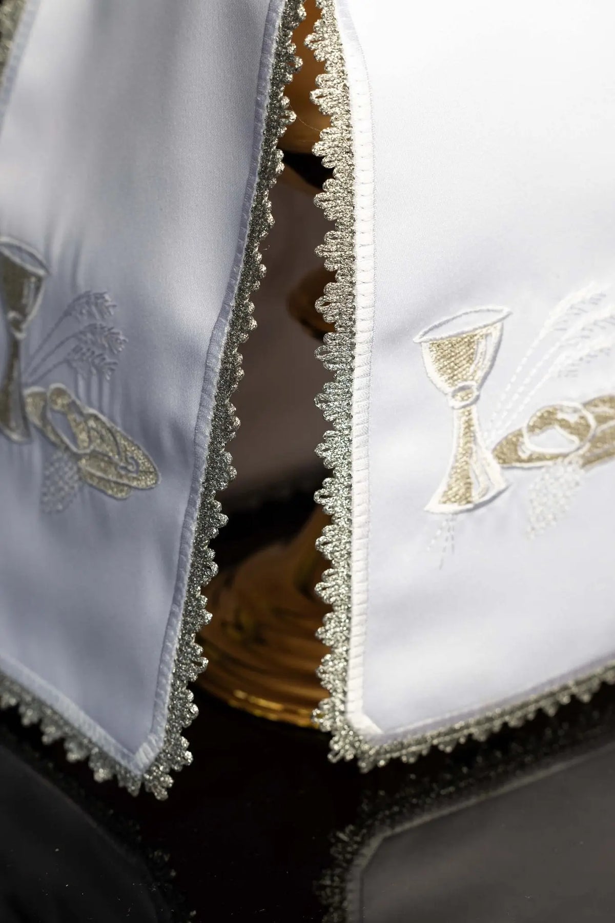 Blanco cubrecopón con cáliz, hostias y espigas bordados, detalle del ribete