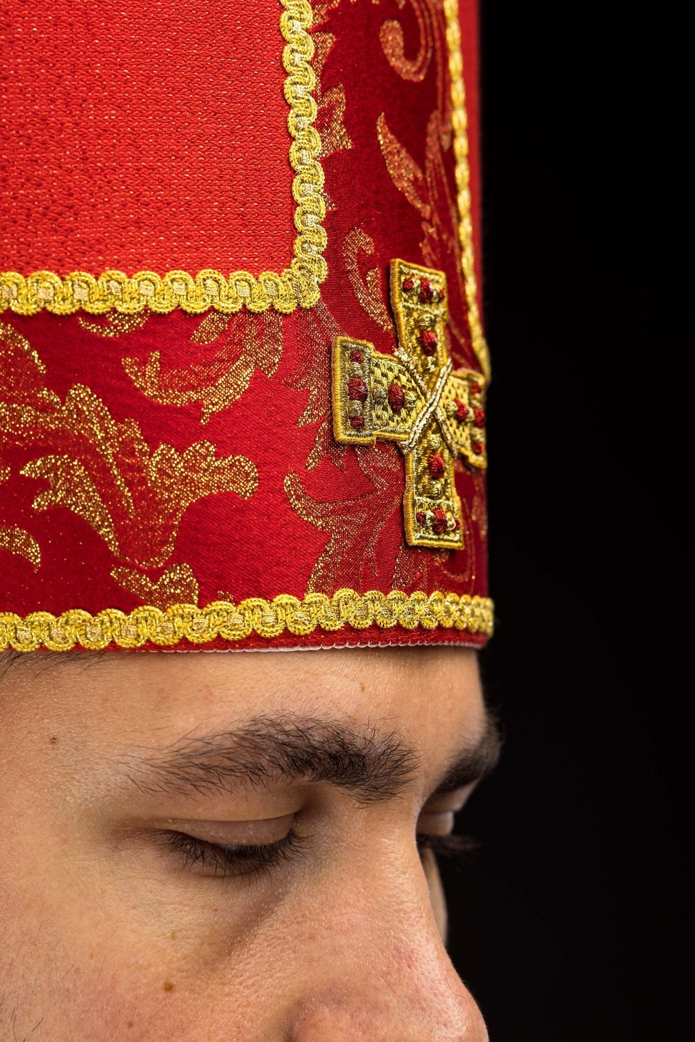 Red embroidered mitre with a cross motif and decorative jacquard fabric
