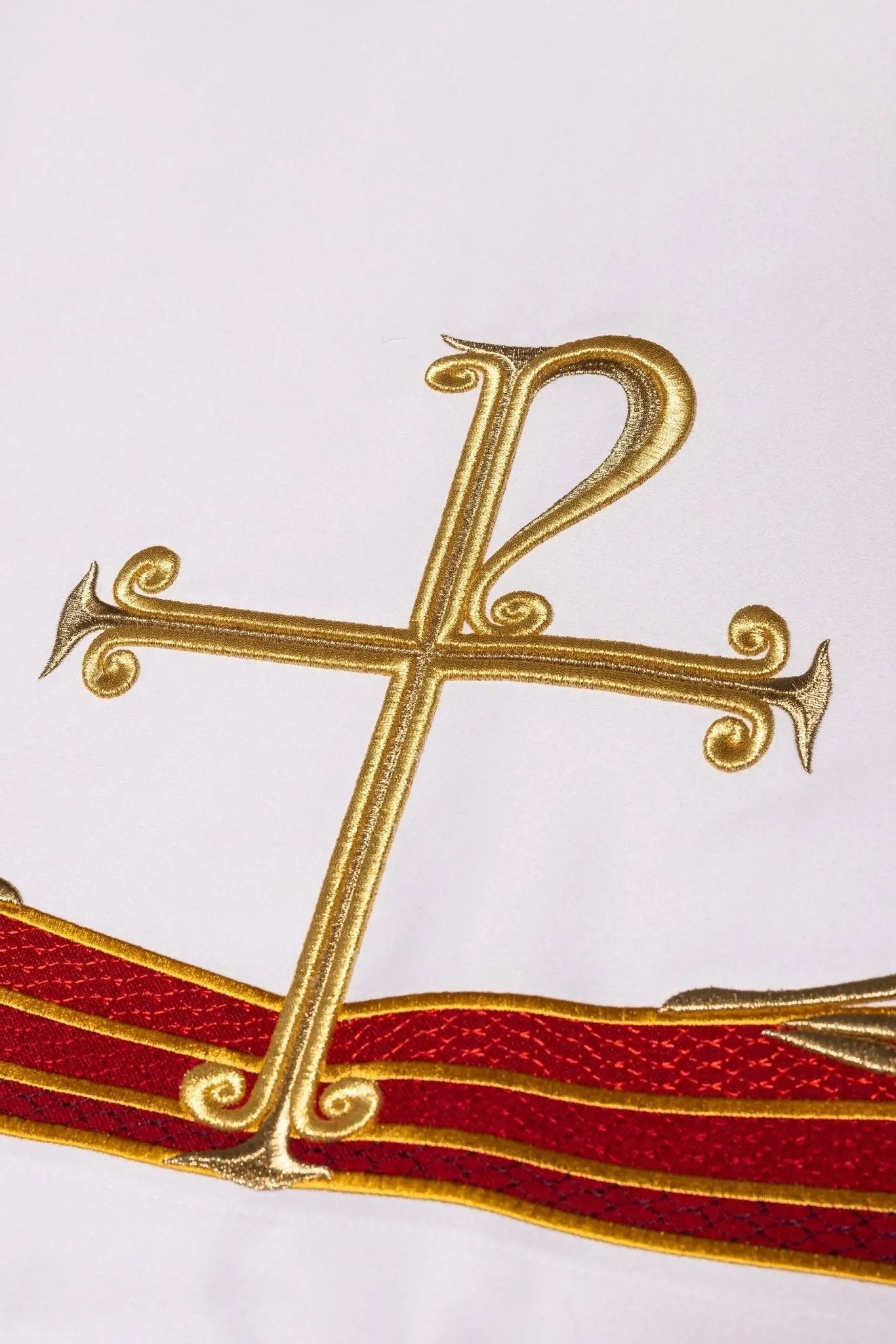 White altar cloth with embroidered Pax symbol, golden wheat sheaves, and red and gold trim