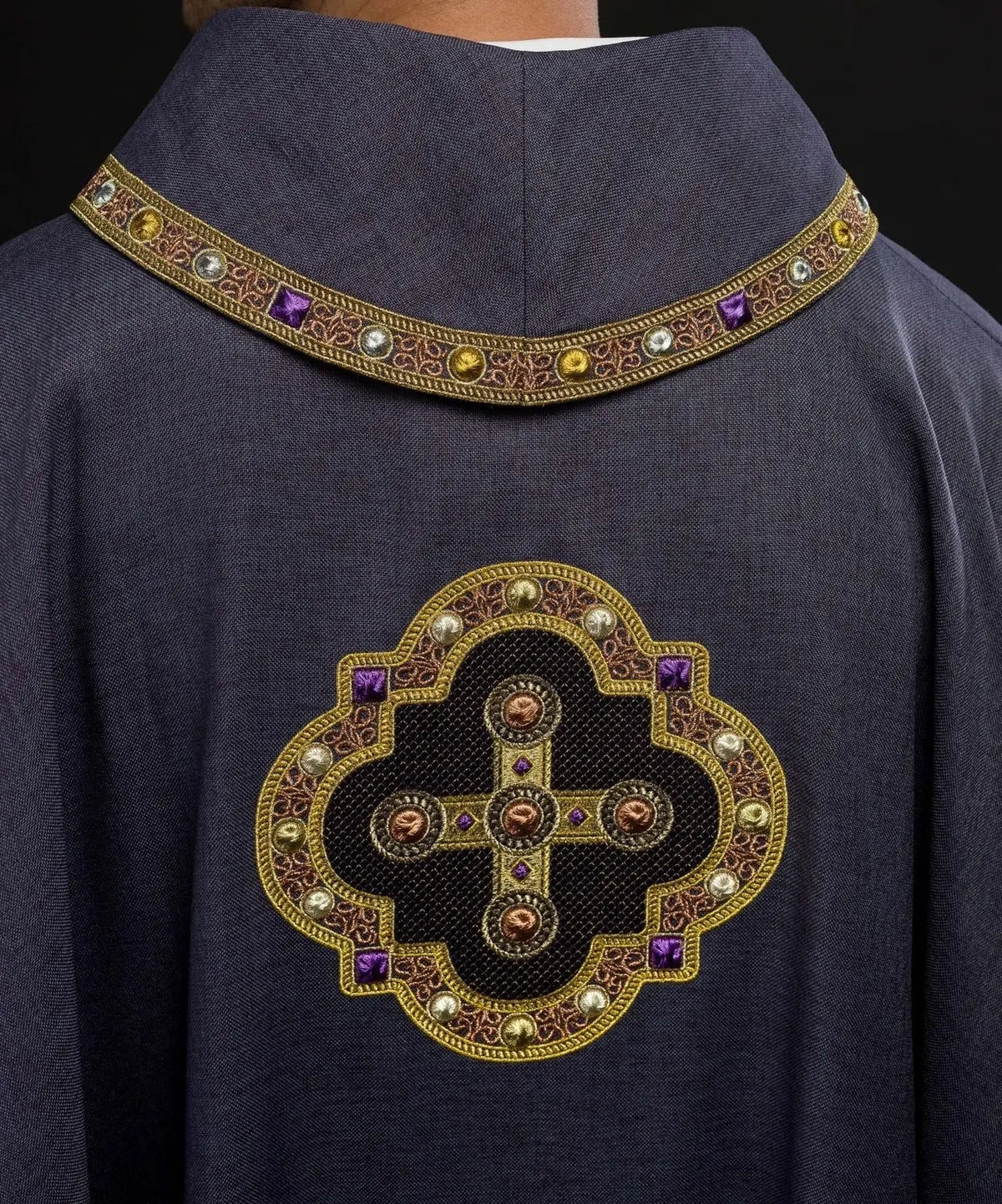 Chasuble in purple with embroidered piping on the collar and around the embroidery of the cross