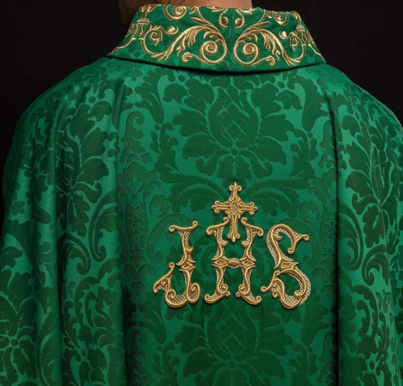 Green chasuble with IHS motif and richly embroidered collar on decorative fabric