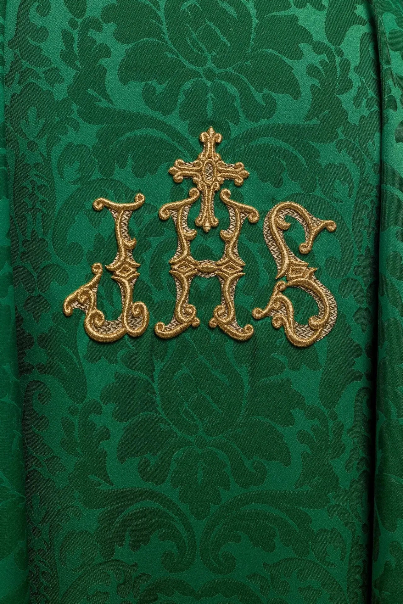 Green chasuble with IHS motif and richly embroidered collar on decorative fabric