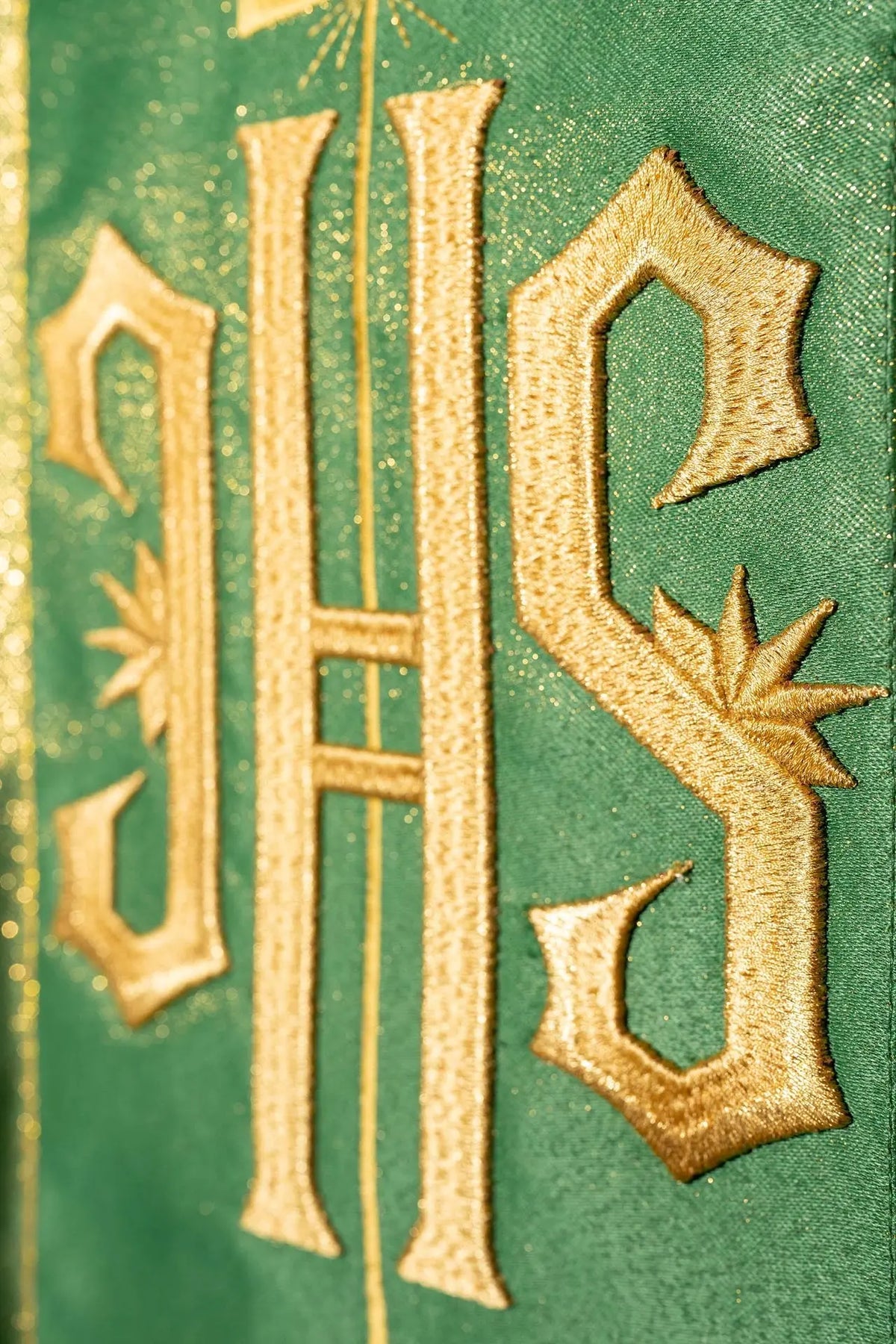 Richly decorated green chasuble with a gold motif and a wide IHS band