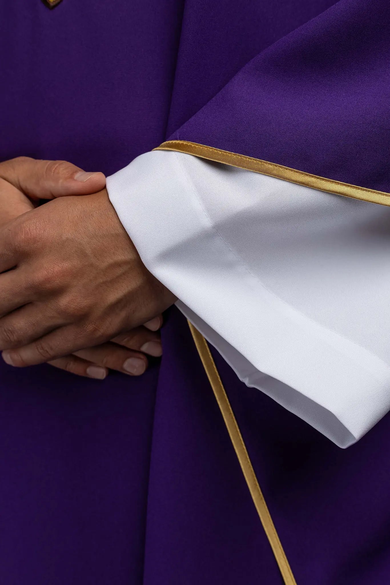 Purple chasuble with embroidered IHS symbol and gold trim, featuring a V-neckline and a matching stole.