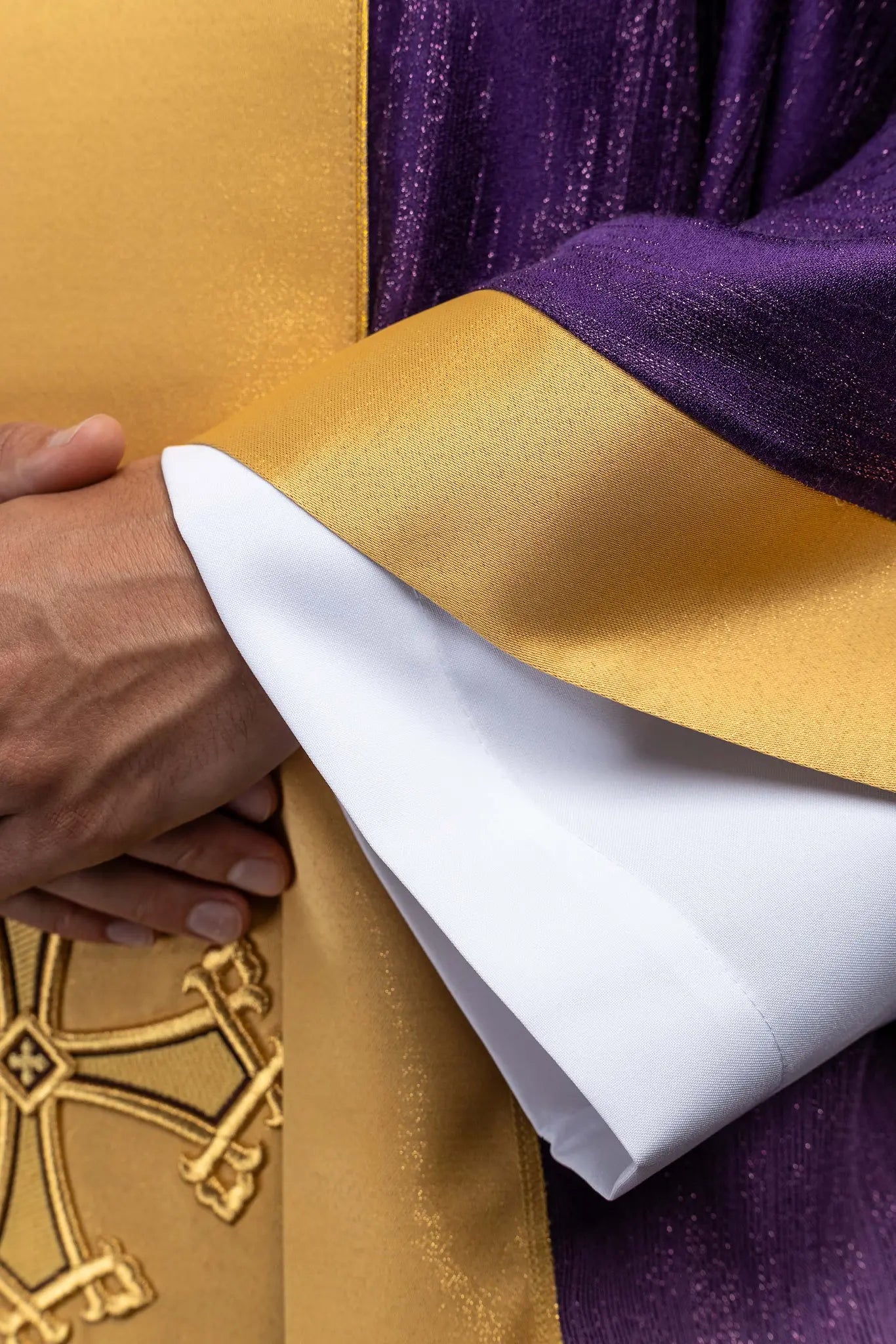 Purple chasuble with a vertical gold band featuring embroidered stylized crosses, gold trim on sleeves and collar, and a stand-up collar.