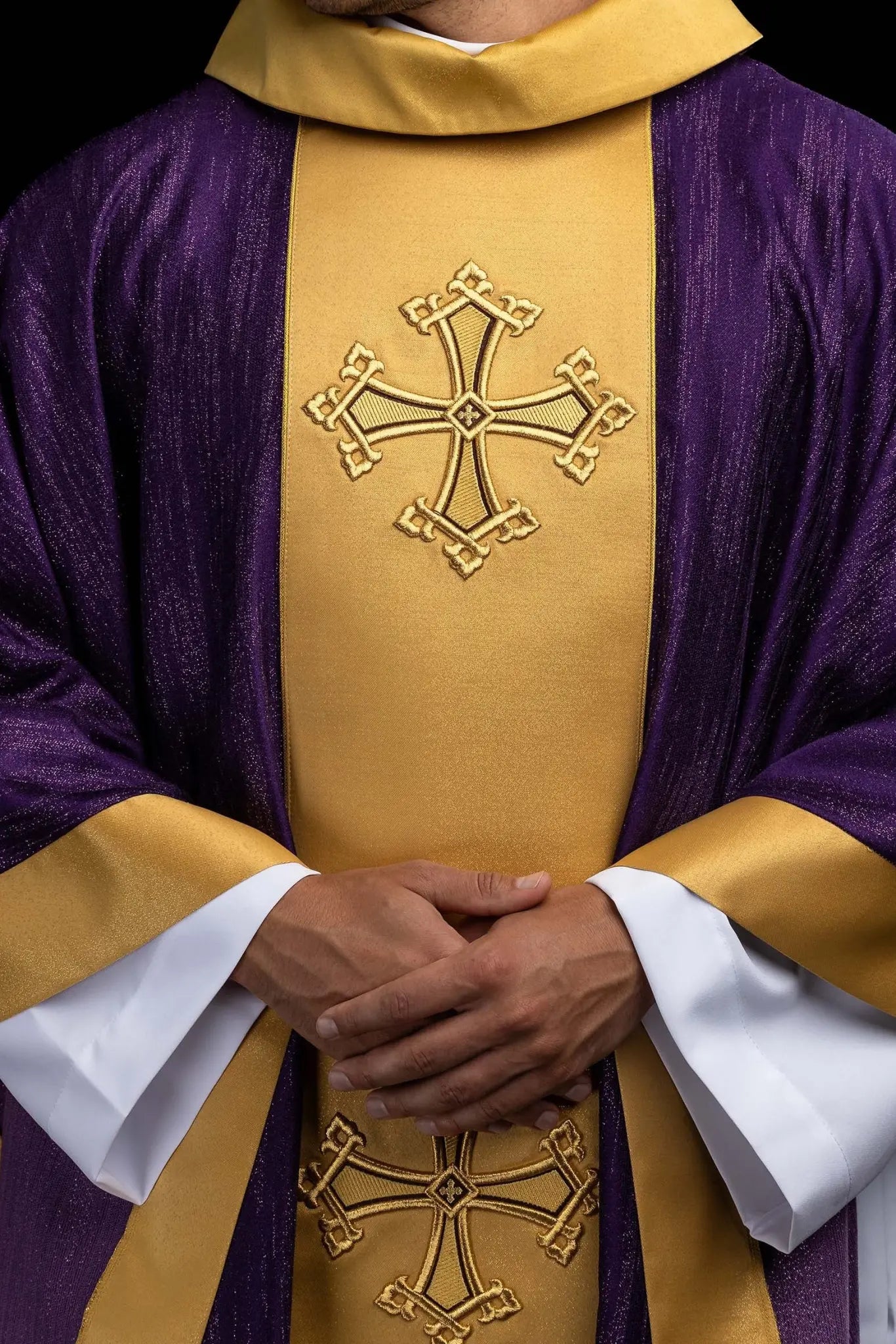 Purple chasuble with a vertical gold band featuring embroidered stylized crosses, gold trim on sleeves and collar, and a stand-up collar.