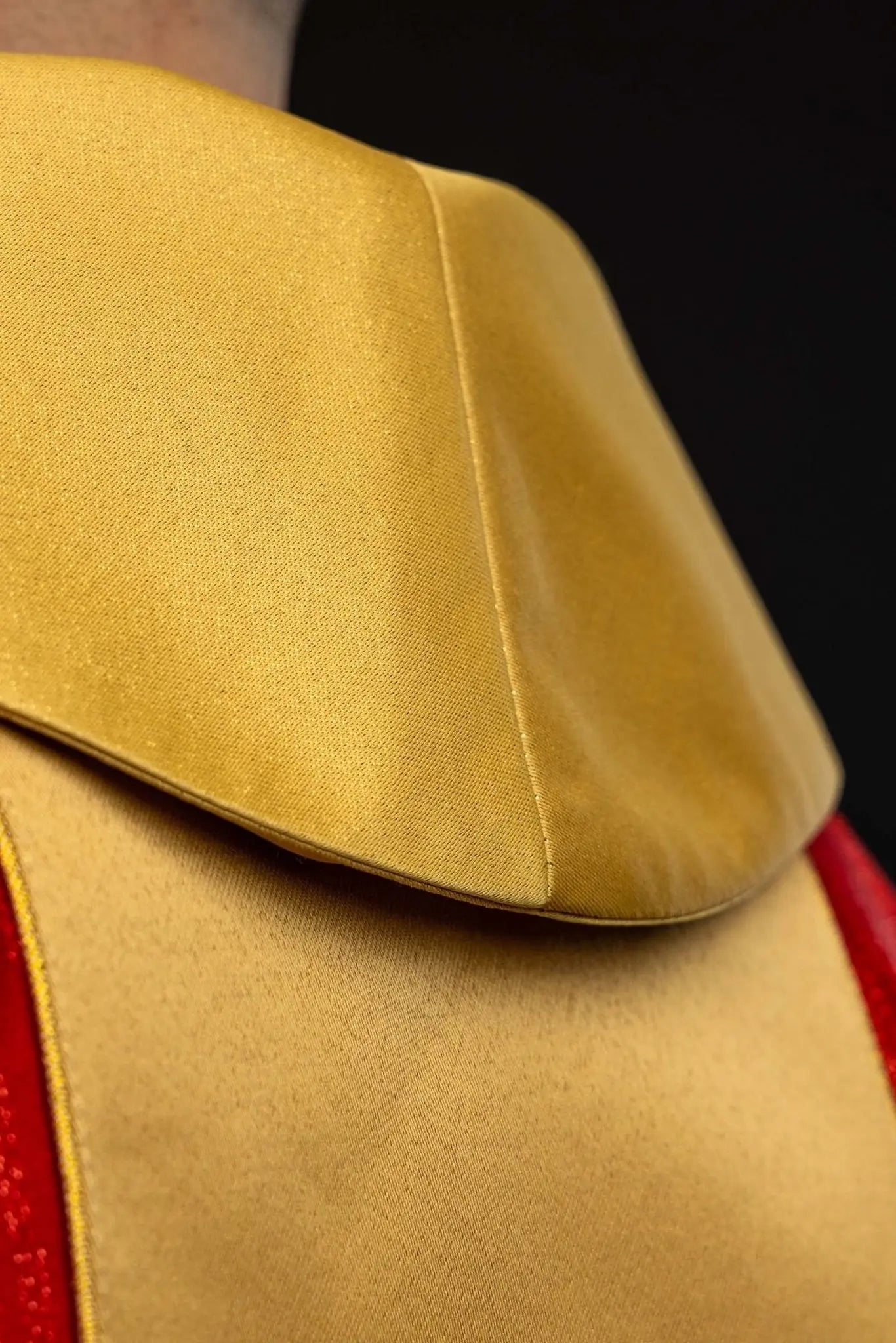 Red chasuble with embroidered cross motif and decorative gold band