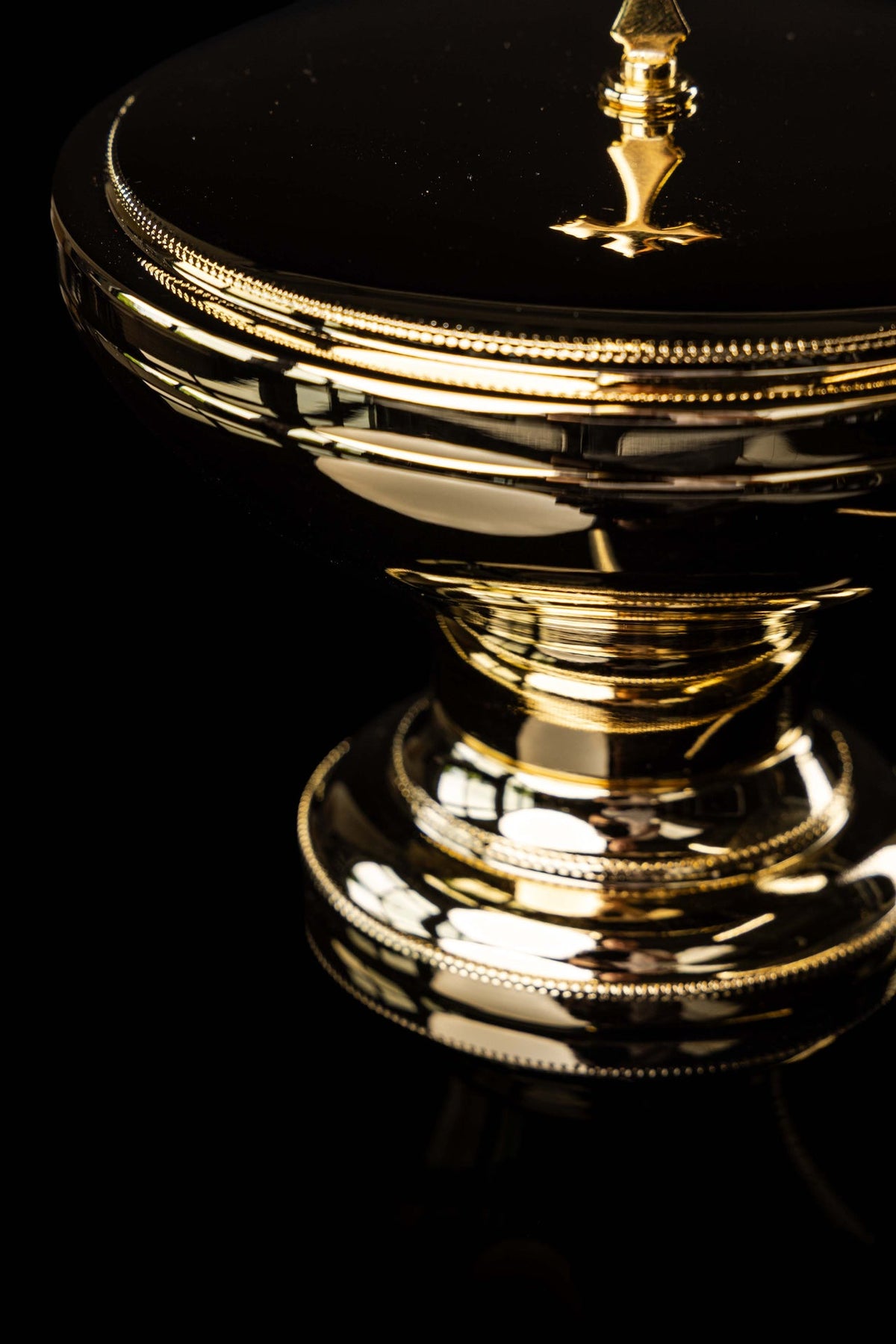 Gold-plated brass ciborium with beaded rim and cross finial, side close-up