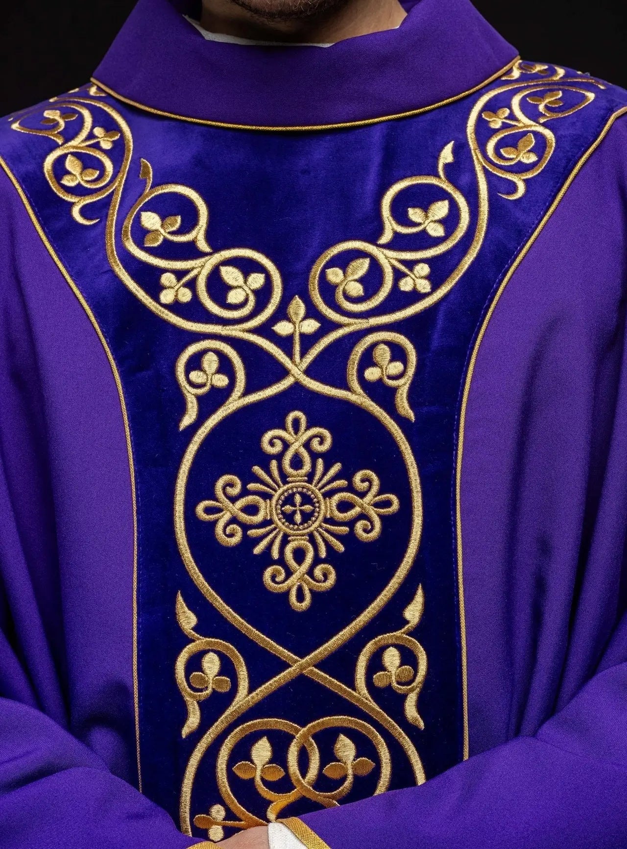 Purple liturgical chasuble decorated with embroidery on velvet