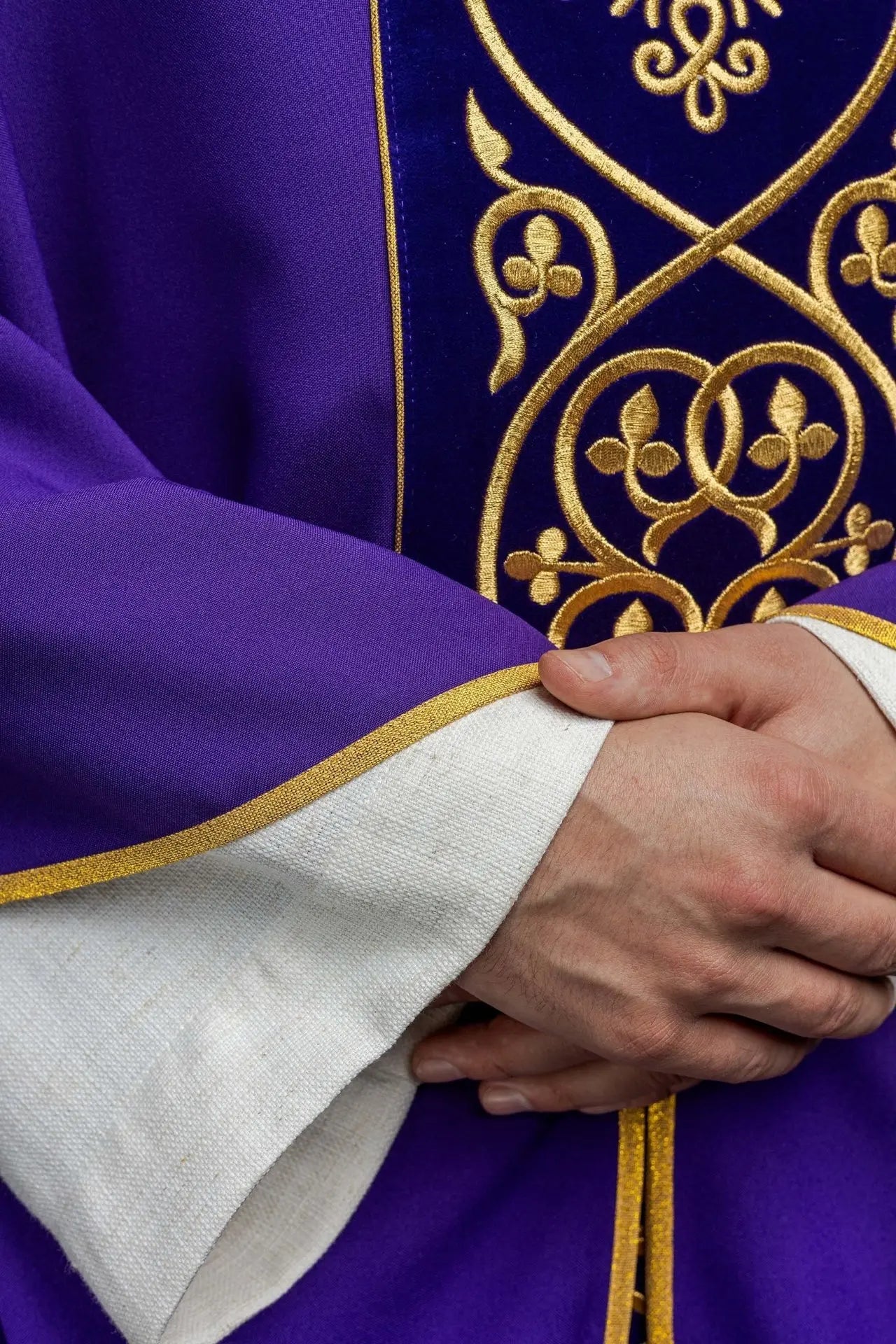 Purple liturgical chasuble decorated with embroidery on velvet