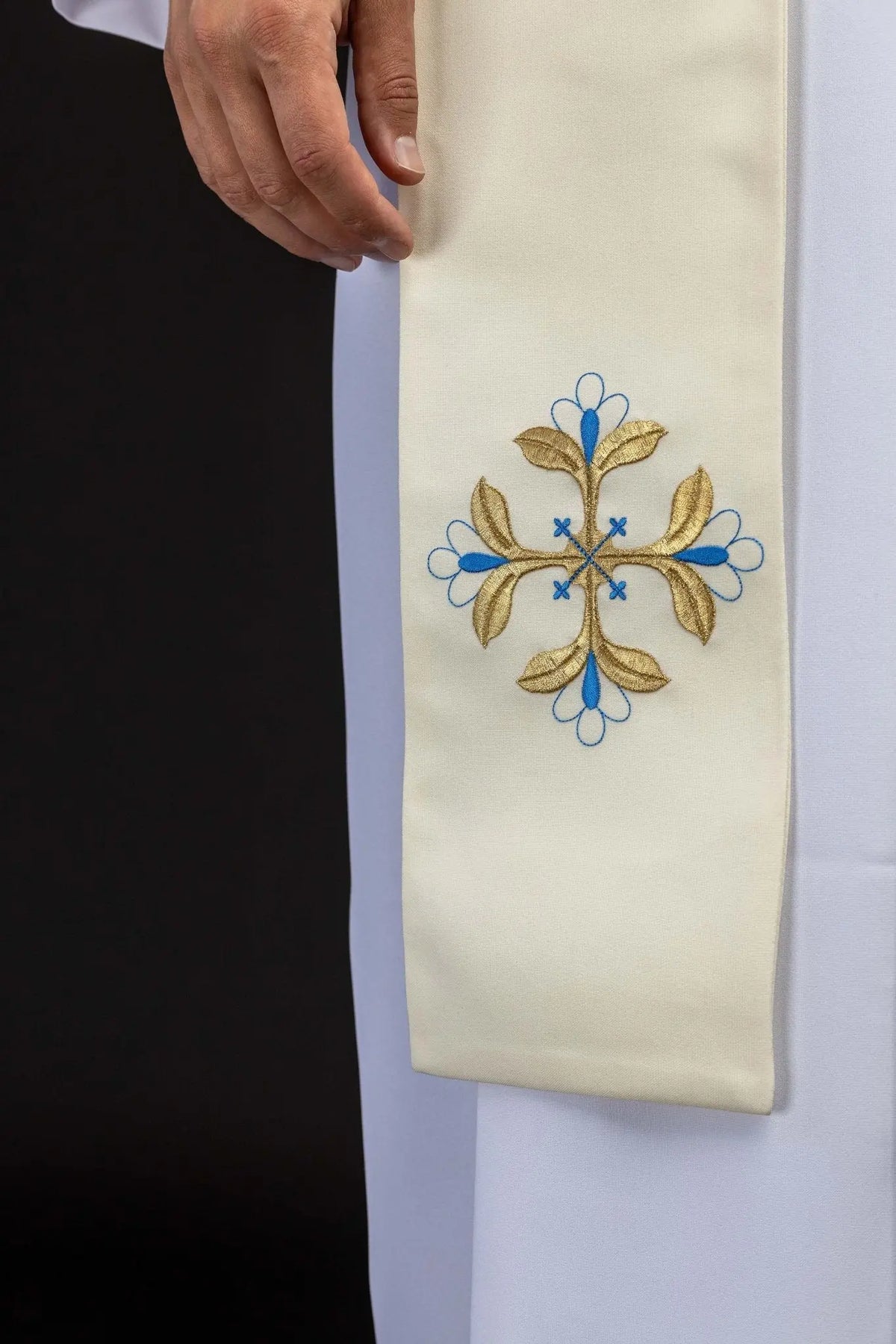 Marfil estola con bordado de cruz floral dorada y azul, detalle del extremo